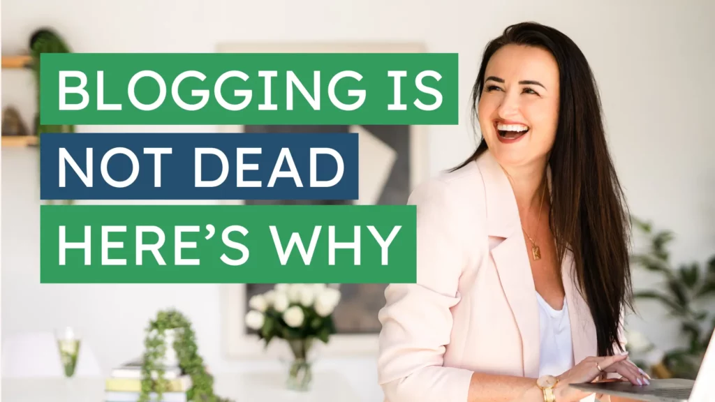 Kelly Sparkes smiling and holding a laptop next to bold text that says "Blogging’s Not Dead — Here’s Why" in a modern office with plants